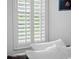 Bedroom with white shutters and bedding at 9052 Misty Creek Dr, Sarasota, FL 34241