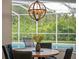 Breakfast nook boasts a round wooden table and dark blue chairs at 9052 Misty Creek Dr, Sarasota, FL 34241