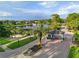 Gated entrance to the community with palm trees and a lake at 9052 Misty Creek Dr, Sarasota, FL 34241