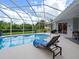 Enjoy this refreshing pool with screened enclosure and lounge chair at 9052 Misty Creek Dr, Sarasota, FL 34241