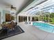 Enclosed patio with pool, dining table, and seating area at 9052 Misty Creek Dr, Sarasota, FL 34241