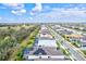 Aerial view of a community with houses, roads, and a lake at 9085 Bernini Pl, Sarasota, FL 34240