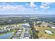 Aerial view of a residential area with houses and a lake at 9085 Bernini Pl, Sarasota, FL 34240