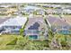Aerial view of homes with solar panels, pools, and lush landscaping at 9085 Bernini Pl, Sarasota, FL 34240