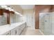 Elegant bathroom with double vanity, quartz countertop and large shower at 9085 Bernini Pl, Sarasota, FL 34240