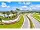 Aerial view of Artistry community entrance with palm trees and lake at 9085 Bernini Pl, Sarasota, FL 34240