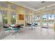 Community room with tables, chairs, and access to pool at 9085 Bernini Pl, Sarasota, FL 34240