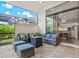 Covered patio with comfortable seating and views of the kitchen at 9085 Bernini Pl, Sarasota, FL 34240