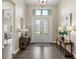 Bright and spacious entryway with wood floors and decorative console tables at 9085 Bernini Pl, Sarasota, FL 34240