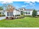 Single-story home with gray garage door and landscaped yard at 9085 Bernini Pl, Sarasota, FL 34240