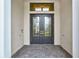 Double front doors with glass inserts and gray frame at 9085 Bernini Pl, Sarasota, FL 34240