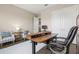 Bright home office with wood desk and comfortable seating at 9085 Bernini Pl, Sarasota, FL 34240