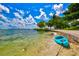 Blue kayak on a sandy beach by calm water at 9085 Bernini Pl, Sarasota, FL 34240