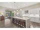 Spacious kitchen with large island, white cabinets, and access to backyard at 9085 Bernini Pl, Sarasota, FL 34240