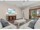 Comfortable living room featuring sectional sofa and large TV at 9085 Bernini Pl, Sarasota, FL 34240