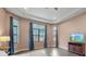 Main bedroom with large windows, TV, and ample space at 9085 Bernini Pl, Sarasota, FL 34240
