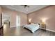 Main bedroom with king bed, view into bathroom and another room at 9085 Bernini Pl, Sarasota, FL 34240