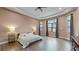 Bright main bedroom with a king-size bed and large windows at 9085 Bernini Pl, Sarasota, FL 34240