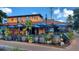 Outdoor patio with tables and umbrellas at a bar at 9085 Bernini Pl, Sarasota, FL 34240