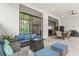 Relaxing patio with seating area and views to the pool and kitchen at 9085 Bernini Pl, Sarasota, FL 34240