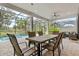 Relaxing covered patio and dining area adjacent to the pool at 9085 Bernini Pl, Sarasota, FL 34240