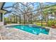 Beautiful screened pool with a natural backdrop at 9085 Bernini Pl, Sarasota, FL 34240