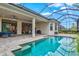 Inviting pool area with covered patio, outdoor kitchen, and ample seating at 9085 Bernini Pl, Sarasota, FL 34240