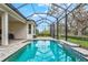 Resort style screened pool with a water feature at 9085 Bernini Pl, Sarasota, FL 34240