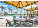 Relaxing poolside seating under covered cabanas at 9085 Bernini Pl, Sarasota, FL 34240