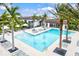 Resort-style pool with ample lounge chairs and palm trees at 9085 Bernini Pl, Sarasota, FL 34240