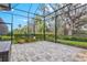 Relaxing screened patio with paver floor and lush landscaping views at 9085 Bernini Pl, Sarasota, FL 34240