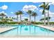 Relaxing pool area with ample lounge chairs and palm trees at 9085 Bernini Pl, Sarasota, FL 34240