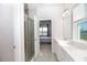 Bright bathroom with double vanity, large mirror, and shower at 9814 Daybreak Gln, Parrish, FL 34219