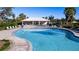 Relaxing community pool with patio and seating area at 9814 Daybreak Gln, Parrish, FL 34219