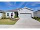 Single story home with two-car garage and landscaped yard at 9814 Daybreak Gln, Parrish, FL 34219