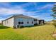 Single-story home with backyard, screened patio, and AC unit at 9814 Daybreak Gln, Parrish, FL 34219
