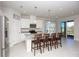 Kitchen boasts an island with seating, stainless steel appliances, and granite countertops at 9814 Daybreak Gln, Parrish, FL 34219
