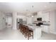 Modern kitchen with granite countertops, white cabinets, and an island at 9814 Daybreak Gln, Parrish, FL 34219