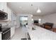 Kitchen features an island, stainless steel appliances, and views to backyard at 9814 Daybreak Gln, Parrish, FL 34219