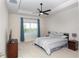 Main bedroom features a ceiling fan, large window, and carpeted floor at 9814 Daybreak Gln, Parrish, FL 34219