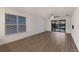 Bright living room with wood-look floors and sliding glass doors leading to the backyard at 10128 Milky Way Cir, Sarasota, FL 34241