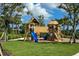 Wooden playground structure with slides and climbing features at 10128 Milky Way Cir, Sarasota, FL 34241