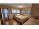 Bedroom with double bed, wood floors, and access to balcony at 10315 Cortez W Rd # 37F, Bradenton, FL 34210