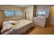 Bedroom with double bed, dresser, and wood floors at 10315 Cortez W Rd # 37F, Bradenton, FL 34210