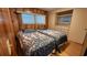 Bedroom with twin beds, wood-paneled walls, and wood floors at 10315 Cortez W Rd # 37F, Bradenton, FL 34210