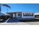 White mobile home with carport, landscaping, and storage shed at 10315 Cortez W Rd # 37F, Bradenton, FL 34210