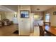 Kitchen with wood cabinets, a dining area, and a view of the living room at 10315 Cortez W Rd # 37F, Bradenton, FL 34210
