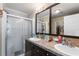 Double vanity bathroom with a large mirror and a walk-in shower at 1106 49Th Avenue W Dr, Bradenton, FL 34207