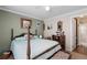 Spacious bedroom with a post bed and ensuite bathroom at 1106 49Th Avenue W Dr, Bradenton, FL 34207