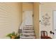 Front entrance with steps, white door, and wall decor at 1106 49Th Avenue W Dr, Bradenton, FL 34207